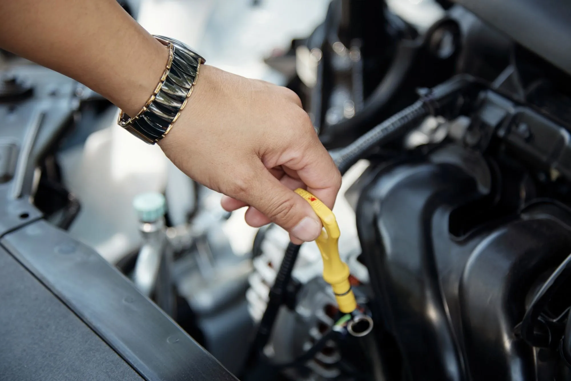 Close up hands of unrecognizable mechanic doing car service and maintenance.